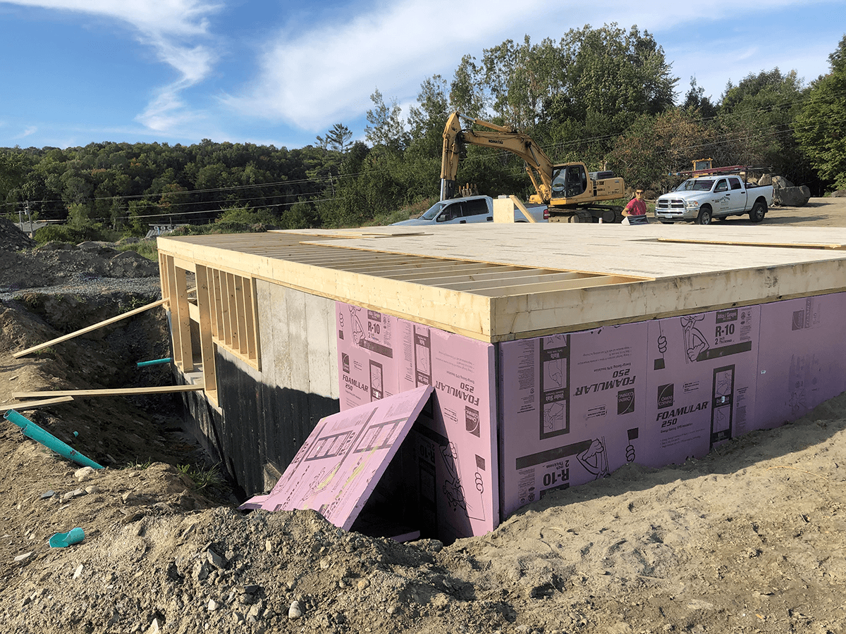 Insulation going onto foundation by Free Range Builders